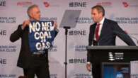 Treasurer interrupted by protesters before giving grim budget warning