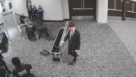Surveillance footage shows gunman charging through officers
