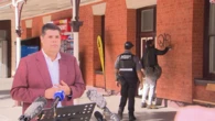 Graffiti protester crashes Queensland transport minister's live press conference