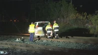 Manhunt for driver after car crashes onto railway tracks