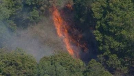 Firefighters working to contain bushfire threatening properties in Brisbane's north-west