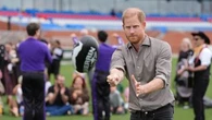 Prince Harry hones his AFL skills on second day of Australian tour
