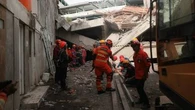 Rescuers run oxygen to survivors in Indonesia school building collapse
