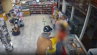 Shirtless armed robber caught on CCTV holding up service station