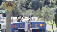 Teenagers who rode on bus roof sought by police
