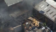 Dozens of firefighters battle blaze at furniture factory in Sydney's west