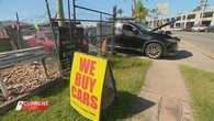 Used car business accused of turning a public street into its own private car park