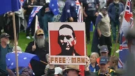 Man charged after displaying Dezi Freeman sign at rally