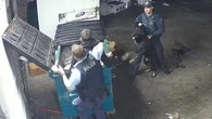 CCTV shows police pulling man from dumpster after alleged armed robbery