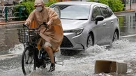 Sudden deluge of rain floods some streets and halts air and rail traffic in Tokyo