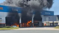 Man fighting for life after fire breaks out at Queensland tyre shop