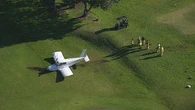 Light plane crash lands on Sydney golf course