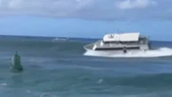 Ferry rides big wave in Hawaii before running aground