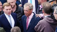 Milkshake thrown at British politician Nigel Farage as he leaves pub