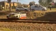 Police narrowly avoid being hit by train chasing motorcyclist in Sydney