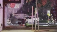 Ute crashes through storefront before shop catches alight