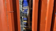 Workers arrested after police open false wall in shipping container