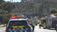 One person trapped after truck crash causes bridge collapse in NSW