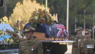 Thousands join military procession for funeral of state's last WWII POW