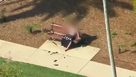 Shirtless man sitting on a park bench arrested after three-hour standoff with police