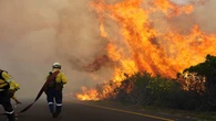 Vehicles burn as Table Mountain wildfire spreads in Tokai