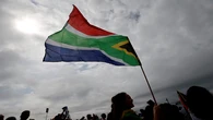 A group of people wearing PAC t-shirts disrupts Human Rights Day commemorations in Sharpville