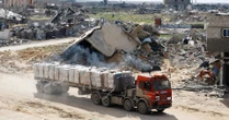 Three reported killed and dozens wounded near aid site in Gaza