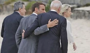 Moment Macron swoops in on Biden for a Covid-breaching whisper seconds after G7 photo