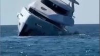 Luxury yacht tips and sinks minutes after launch as terrified passengers jump overboard
