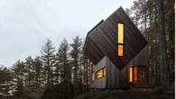 Off-grid cabin design required a helicopter installation