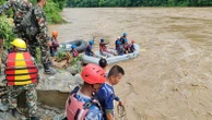 Bodies found after buses swept into river by landslide, officials say