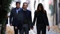 Ex-French president Nicolas Sarkozy holds hands with wife as he prepares to enter prison