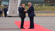Red carpets and flypasts: In Alaska, an indicted war criminal was feted like a king