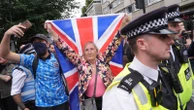 Rival groups face off outside migrant hotel - as asylum seekers 'blow kisses' at protesters