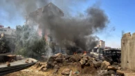 Inside besieged Syrian city ravaged by sectarian violence - where bodies line streets and homes are burned