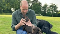 Prince of Wales plays with family dog and her new puppies in picture marking 43rd birthday