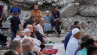 Gazans pray in rubble at start of Eid - as Israel warns of intensive new military operations