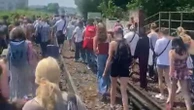 Rail passengers have to walk along tracks on hottest day of year after fault bring trains to halt