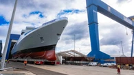 Royal Navy warship emerges from shipbuilding hall