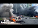 Shocked Ukrainians leave apartment block after Russian bomb hits Kharkiv