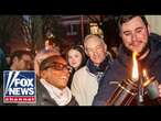 Embattled Harvard president attends campus menorah lighting