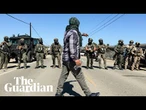 Protesters and US federal agents clash during immigration raid at California farm