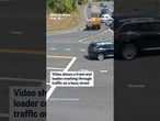 Video shows a front-end loader crashing through traffic on a busy street