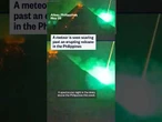 A meteor is seen soaring past an erupting volcano in the Philippines