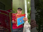 Hummingbird flutters around man reading book about how to attract hummingbirds