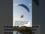 A shocked witness captured the moment a paraglider crashed into power lines in North Dakota