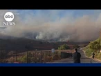 Residents flee wildfires in West, storms slam Northeast