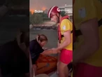Moment desperate people are rescued after running into the SEA to escape wildfires on holiday island