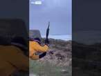 Man battles fierce gusts to measure wind speed