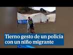 Un policía ayuda a un niño migrante a andar en bicicleta por primera vez